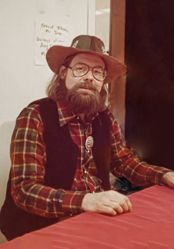 Author Alexei Panshin in brown cowboy hat, black vest, and flannel shirt. Image source: file770.com